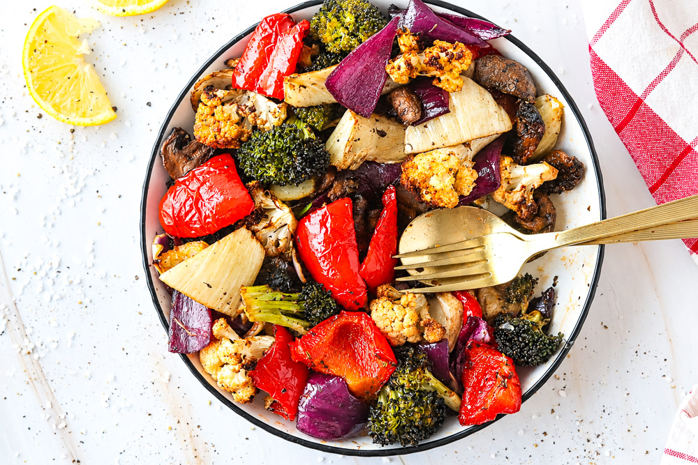 Assiette de légumes marinés rôtis au Air Fryer avec brocoli, chou-fleur, poivron rouge, oignon rouge, fenouil et champignons cremini.